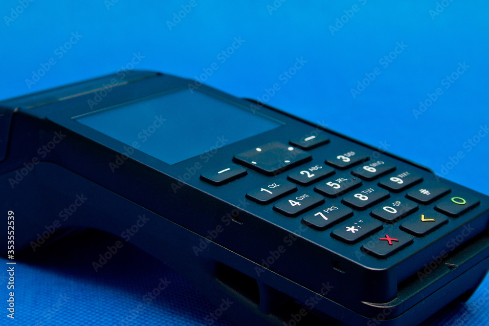 Credit card reader on a blue background close up Credit card reader on a blue background close up