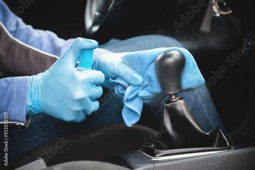 The driver handles the gear knob with an antiseptic.
