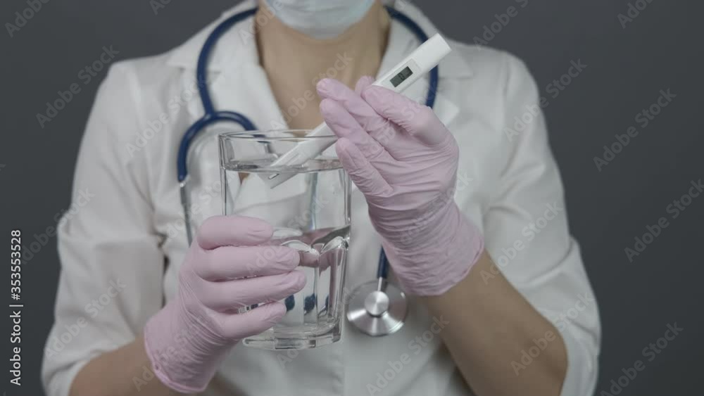 Doctor testing water. The laboratory assistant tests the water in a glass. Doctor testing water. The laboratory assistant tests the water in a glass.