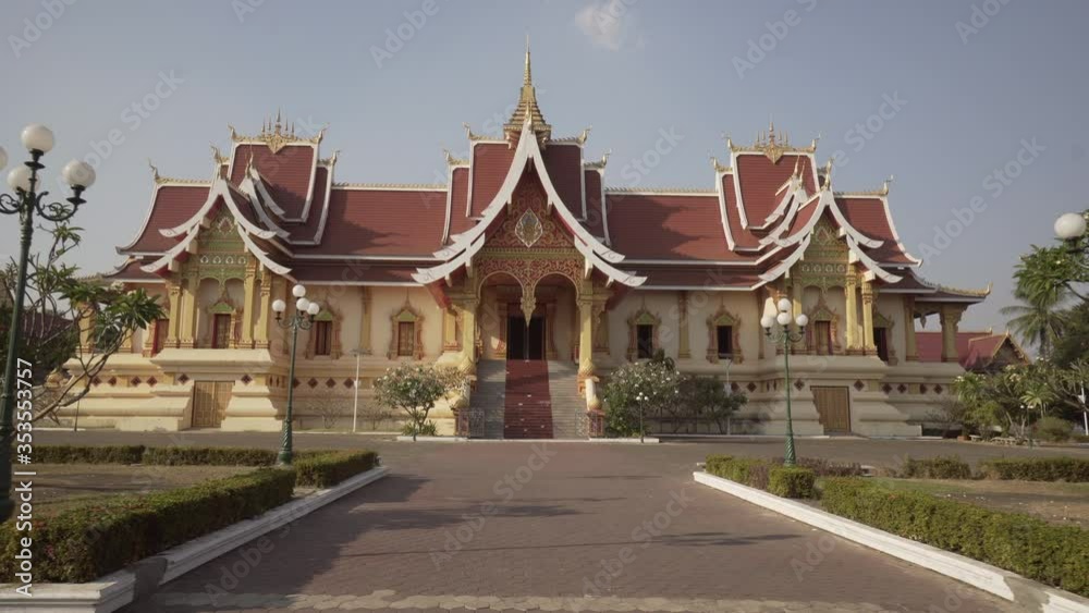 Footpath leading towards facade of famous hall with staircase against sky during sunny day - Vientiane, Laos Footpath leading towards facade of famous hall with staircase against sky during sunny day - Vientiane, Laos