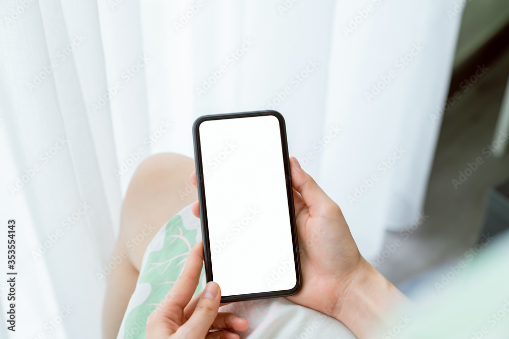 Hand holding smartphone mockup of blank screen on the table. Take your screen to put on advertising. Hand holding smartphone mockup of blank screen on the table. Take your screen to put on advertising.