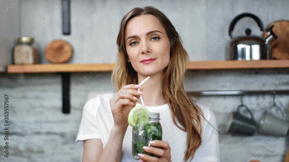 Portrait of happy lady drink cocktail with lime and mint. Medium close up shot on 4k RED camera Portrait of happy lady drink cocktail with lime and mint. Medium close up shot on 4k RED camera