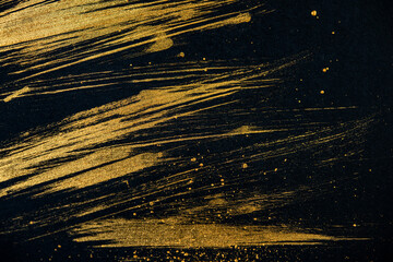 Strokes with Golden Paint Brush on Black Paper.