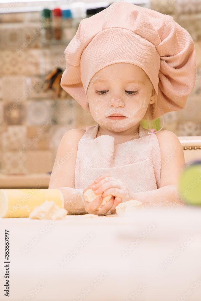 Little girl cooks at home in the kitchen Little girl cooks at home in the kitchen