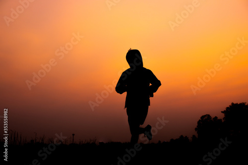 Black silhouette taken from exercise at sunset,running