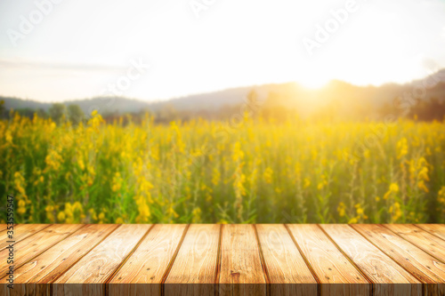 Empty wooden table space platform and blurred field or farm background for product display montage