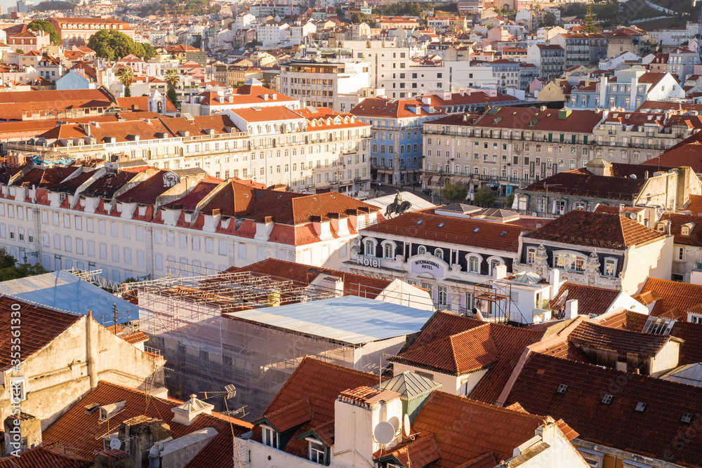 Panoramic view of Lisbon red and orange roofs at sunrise, Portugal