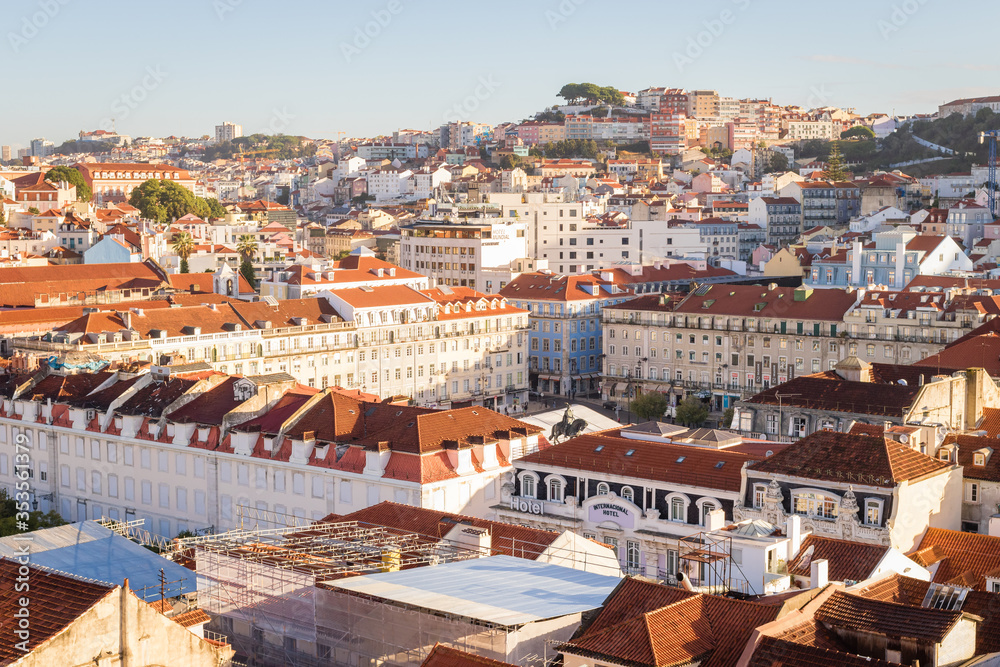 Panoramic view of Lisbon red and orange roofs at sunrise, Portugal
