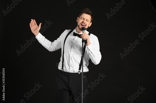 Handsome man singing agains...