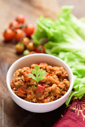 Northern Thai food (Nam Prik Ong), spicy chili minced pork with tomatoes in a bowl