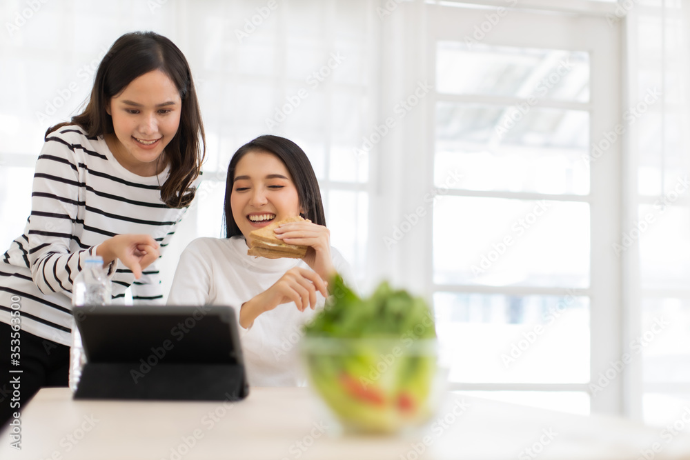 Online Group Video Call Conference of Work Team from Home Office.Smiling young asian woman sit at home speaking.online with internet .friend work from home and eat breakfast together. Online Group Video Call Conference of Work Team from Home Office.Smiling young asian woman sit at home speaking.online with internet .friend work from home and eat breakfast together.