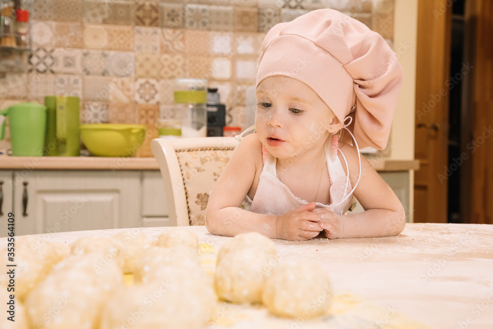 Little girl cooks at home in the kitchen Little girl cooks at home in the kitchen