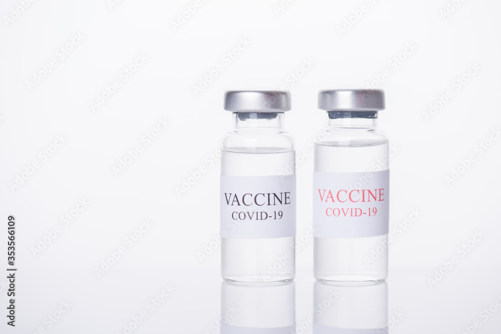 Immunization and COVID-19 treatment concept. Close-up photo of two COVID-19 vaccine vials isolated on white background Immunization and COVID-19 treatment concept. Close-up photo of two COVID-19 vaccine vials isolated on white background