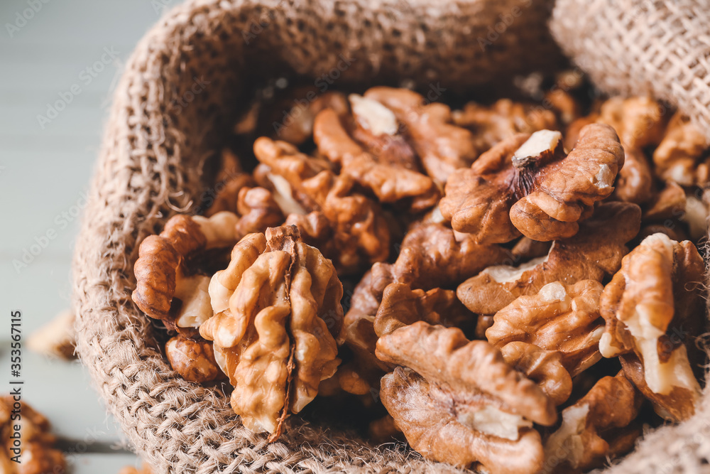 Obraz premium Bag with tasty walnuts, closeup
