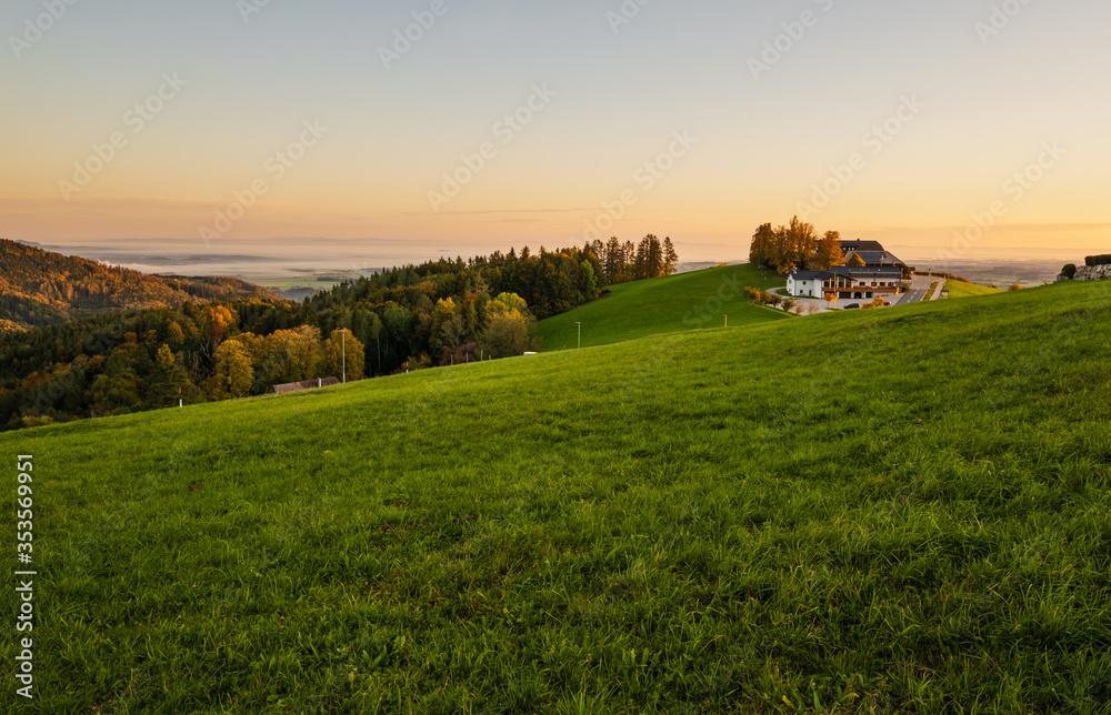 Fototapeta premium Peaceful autumn Alps mountain lake with clear transparent water and reflections. Sunrise view to Traunsee lake, Gmundnerberg, Altmunster am Traunsee, Upper Austria.