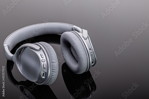 Bluetooth wireless headphones. Modern devices for listening to music. Studio shot, copy space.