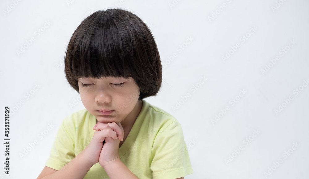 kid praying in morning, hands folded in prayer
kid praying in morning, hands folded in prayer