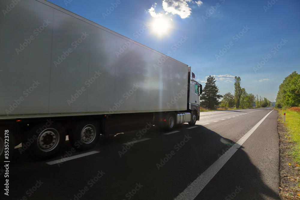 White truck transport on the road at sunset and cargo White truck transport on the road at sunset and cargo