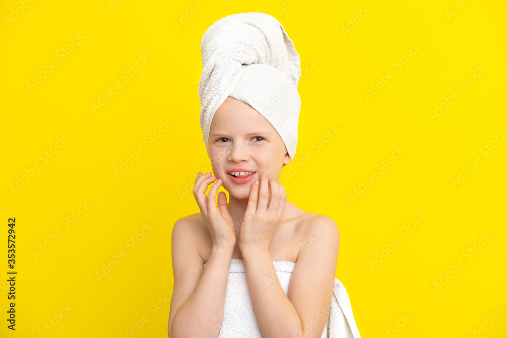 Portrait of cute little caucasian girl wrapped in white towel with bath towel on head over yellow studio background. Spa procedure, bath textile. Portrait of cute little caucasian girl wrapped in white towel with bath towel on head over yellow studio background. Spa procedure, bath textile.