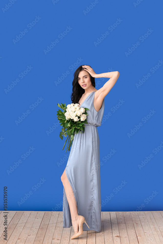 Beautiful young woman with bouquet of roses on color background Beautiful young woman with bouquet of roses on color background