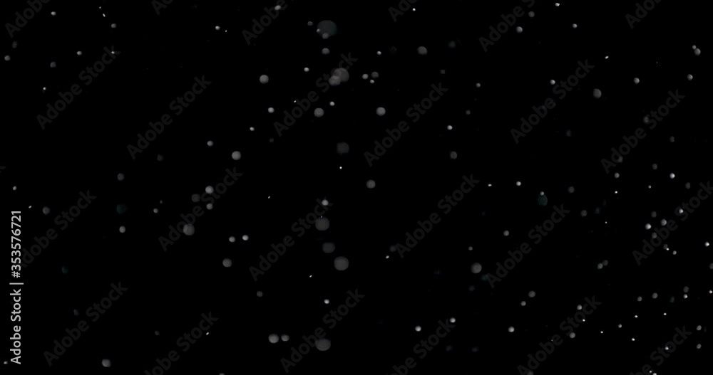 Blizzard of snow at night. It shows the white flakes moving fast on the isolated black background. Blizzard of snow at night. It shows the white flakes moving fast on the isolated black background.