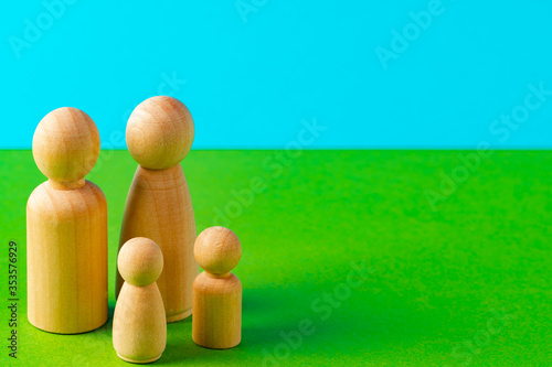 Small wooden figures of family members. Family relationship symbol