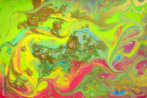 Fluorescent abstract pattern with golden powder scattering.