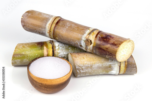 White sugar in wooden bowl with sugar cane cut isolated on white background, Food and Dring
