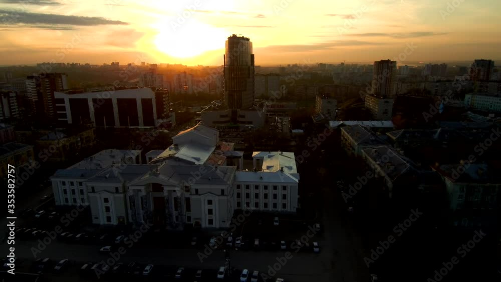 Aerial shot.Sunset in a modern city.The sun is reflected in the skyscraper.Orange sky. Aerial shot.Sunset in a modern city.The sun is reflected in the skyscraper.Orange sky.