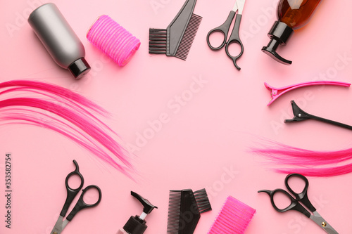 Frame made of hairdresser supplies on color background