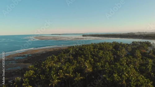Wallpaper Mural Bird eye view of reef break point in low tide at sunset surrounded by palm trees and Pacific Sea warm waters at golden hour in Siargao Island, Philippines. Summer, travel and vacation concept. Torontodigital.ca