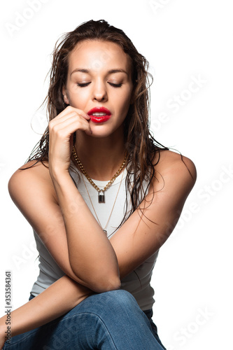 Playful. Portrait of beautiful stylish woman isolated on white studio background. Caucasian brunette model with bright red lipstick, wet hair and shiny skin. Beauty, fashion, emotions concept.