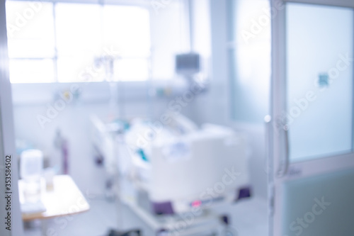 Blurred ICU room in a hospital with medical equipments and patient. © workphoto