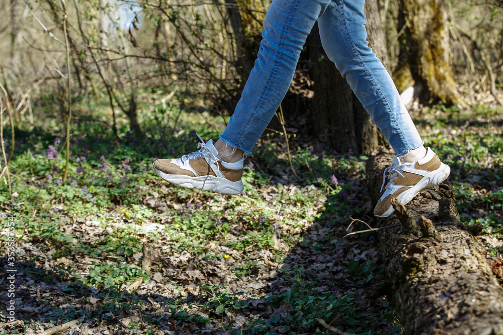 legs of a girl walking in the forest legs of a girl walking in the forest