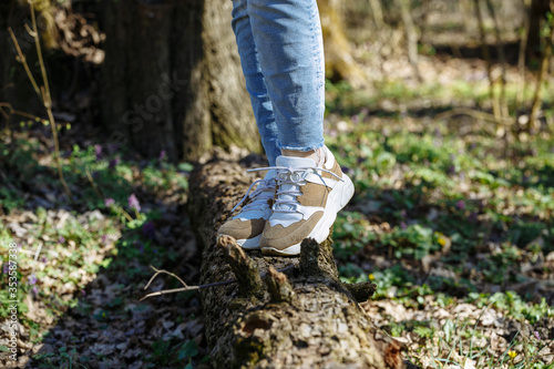 legs of a girl walking in the forest
