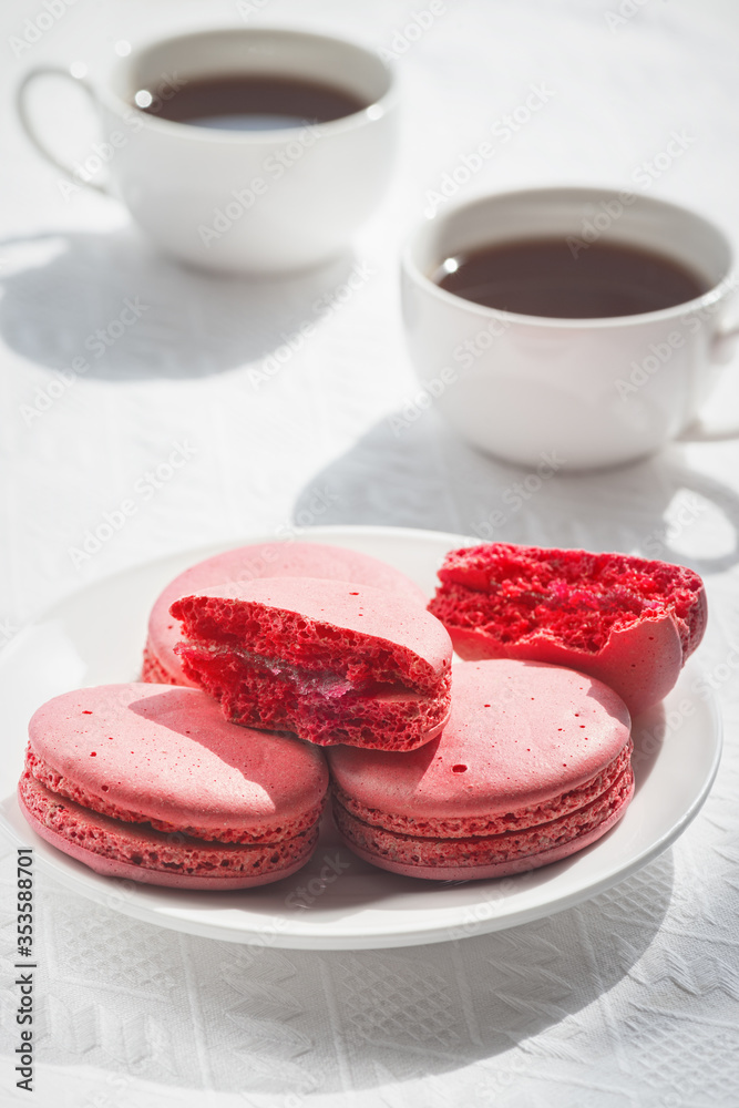 Macaroons and coffee cup on white wood table. Macaroons and coffee cup on white wood table.