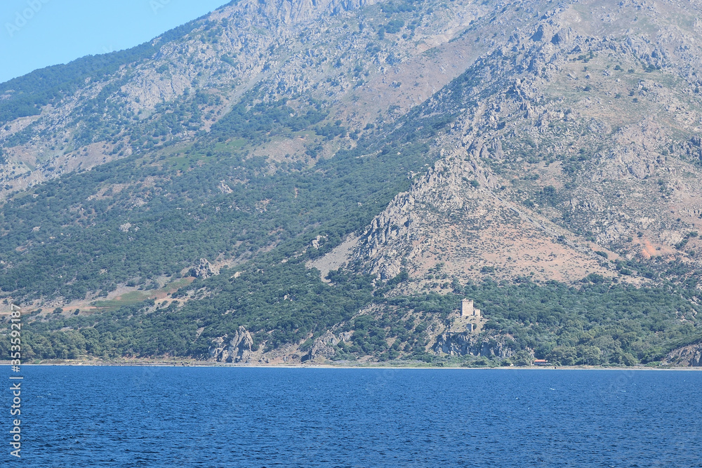 Seascape with Saos mountain and coastline- medieval tower near Paleopoli - Samothraki island view from ferry - Greece, Aegean sea