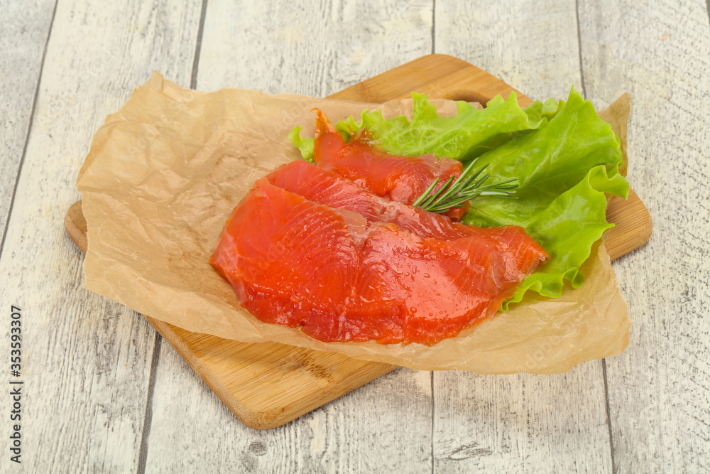 Sliced salmon fillet served rosemary