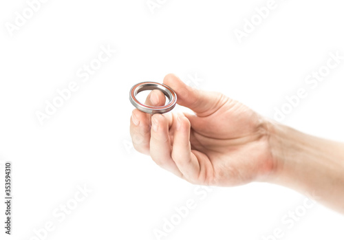 The hand holds the closed bearing. Close up. Isolated on a white background