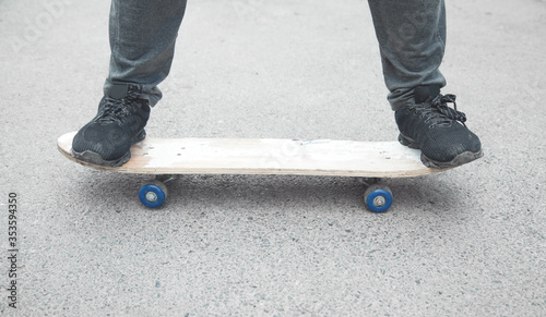 Boy rides on skateboard in the asphalt.