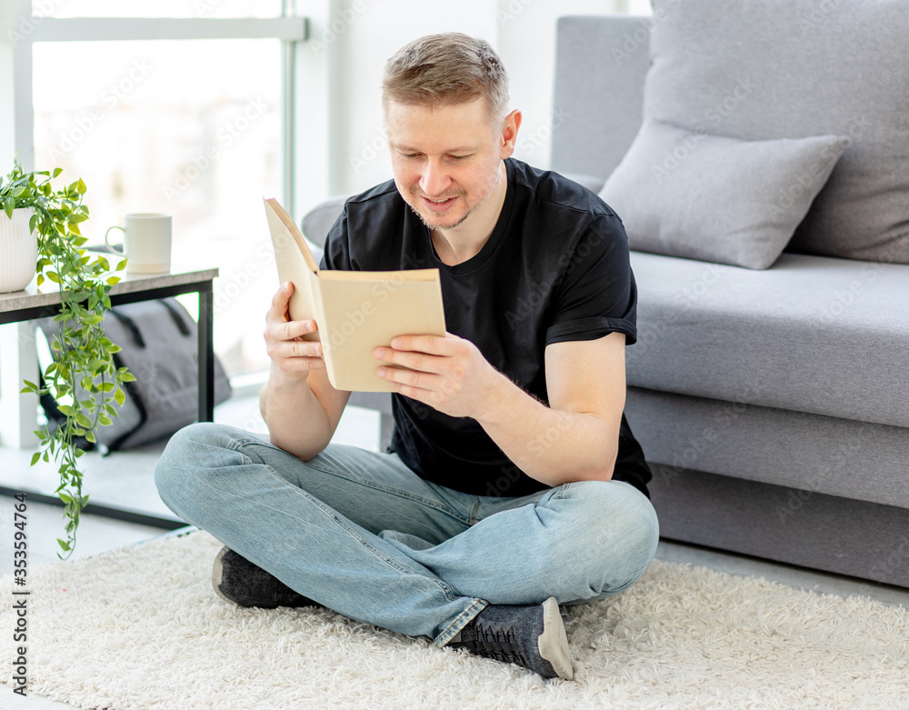 Attractive man reading paper book