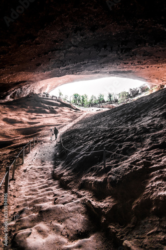 Pareja caminando de la mano caminando en las famosas Cuevas del Milodón. Chile photo