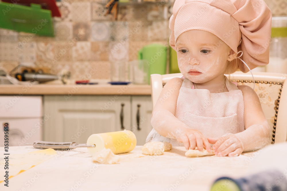 Little girl cooks at home in the kitchen Little girl cooks at home in the kitchen