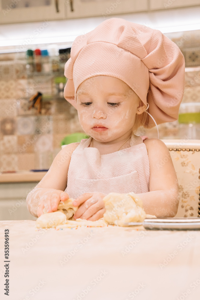 Little girl cooks at home in the kitchen Little girl cooks at home in the kitchen