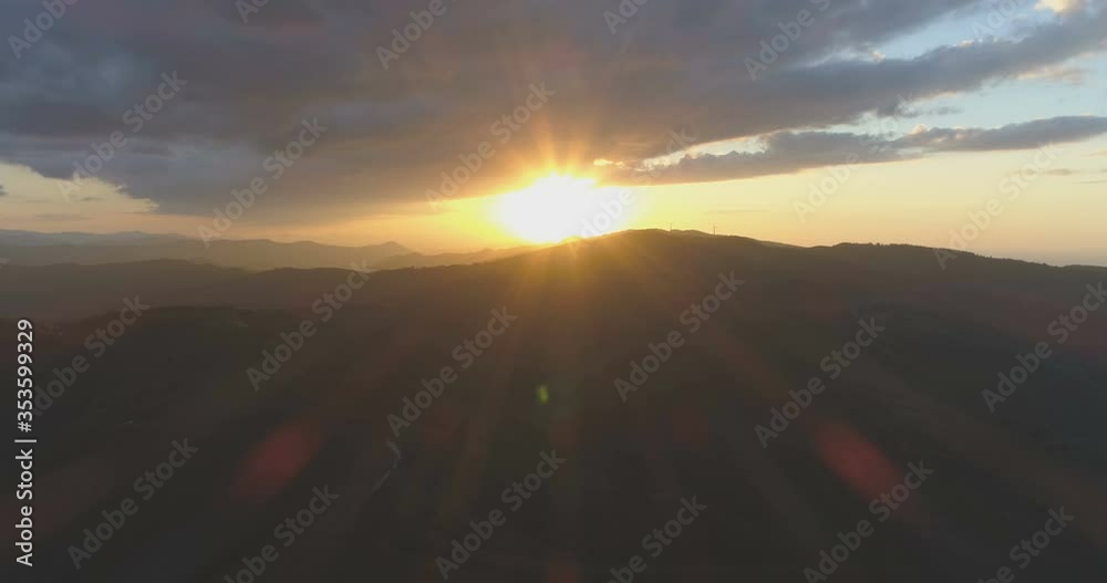BIg Gray clouds above warm yellow sunset in the mountains BIg Gray clouds above warm yellow sunset in the mountains