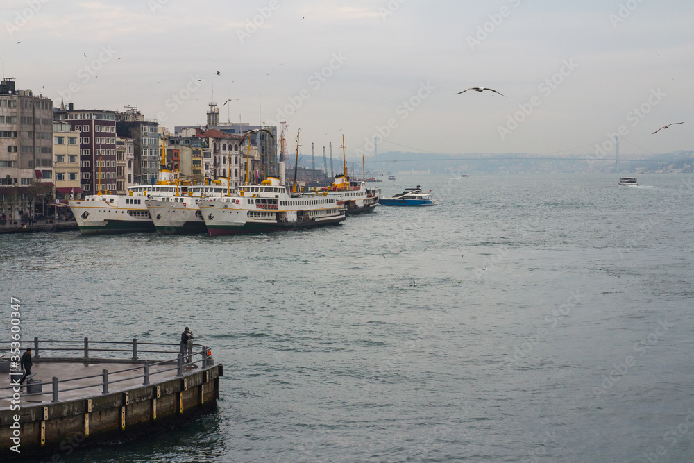 Ferries on the pier at rainy weather in Istanbul. Turkey