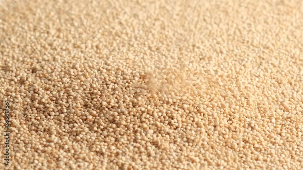 White raw quinoa rotating and falling, South American grain. Healthy and gluten free food concept background. White raw quinoa rotating and falling, South American grain. Healthy and gluten free food concept background.