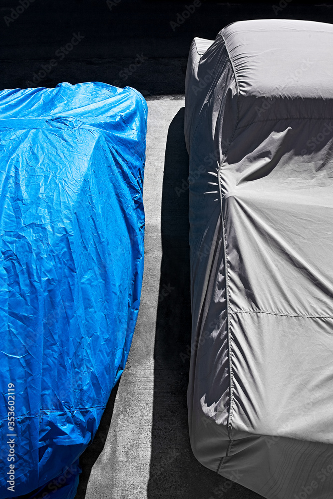 close-up of cars covered with covers