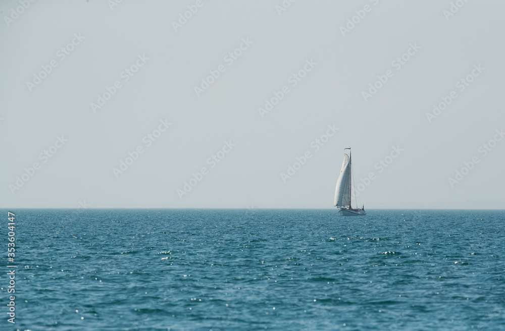 Tourists enjoying on a traditional boat with mast and sails in Arabian Gulf on Febrauary 09 , 2018 near Asker, Bahrain