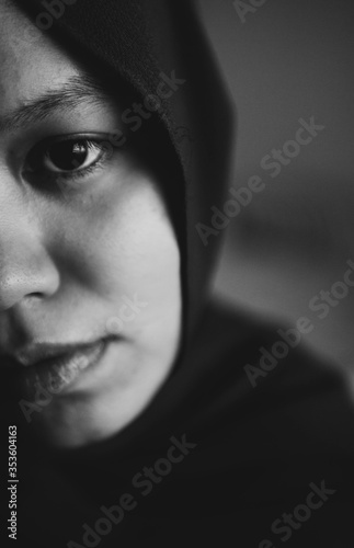 A young Muslim woman looking sad